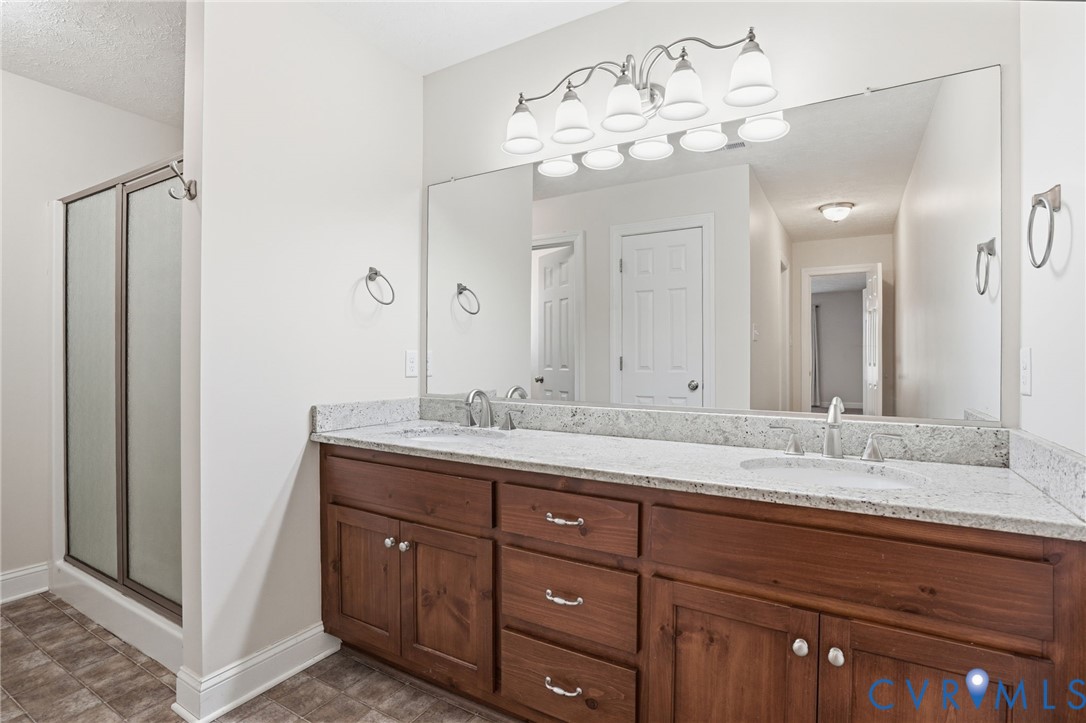 10326 Gould Hill Road Hanover, VA 23069 - Photo 22 of 43 a bathroom with a granite countertop double vanity sink and a mirror