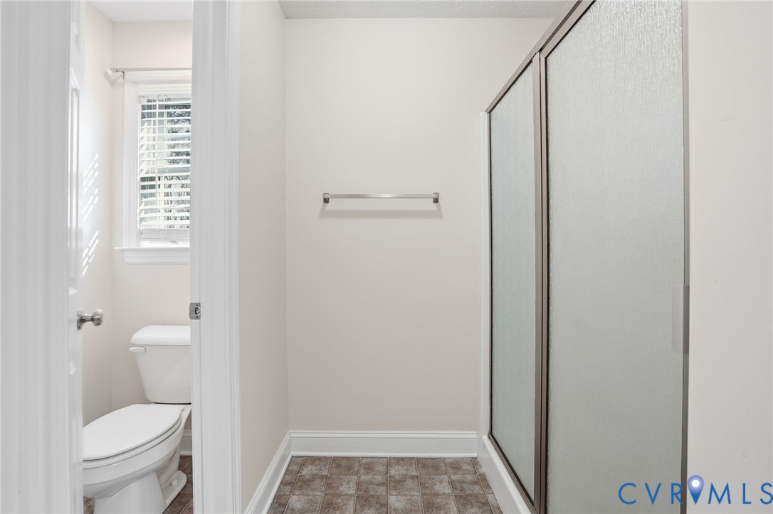 10326 Gould Hill Road Hanover, VA 23069 - Photo 24 of 43 a bathroom with a granite countertop toilet and a shower