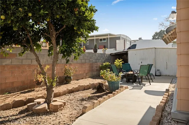 a view of backyard with a table and chairs and potted plants