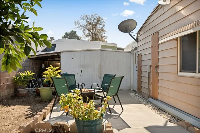 a view of balcony with couple of chairs and potted plants