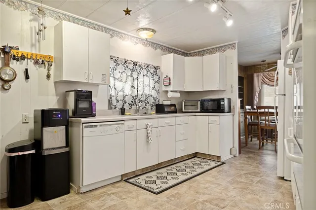 a kitchen with stainless steel appliances a refrigerator sink and cabinets