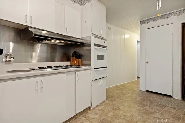 a kitchen with cabinets and appliances