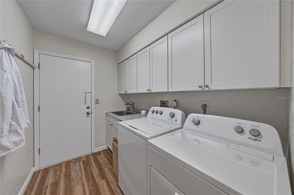 7435 Kilbride Court Weeki Wachee, FL 34613 - Photo 23 of 67 a utility room with dryer and washer