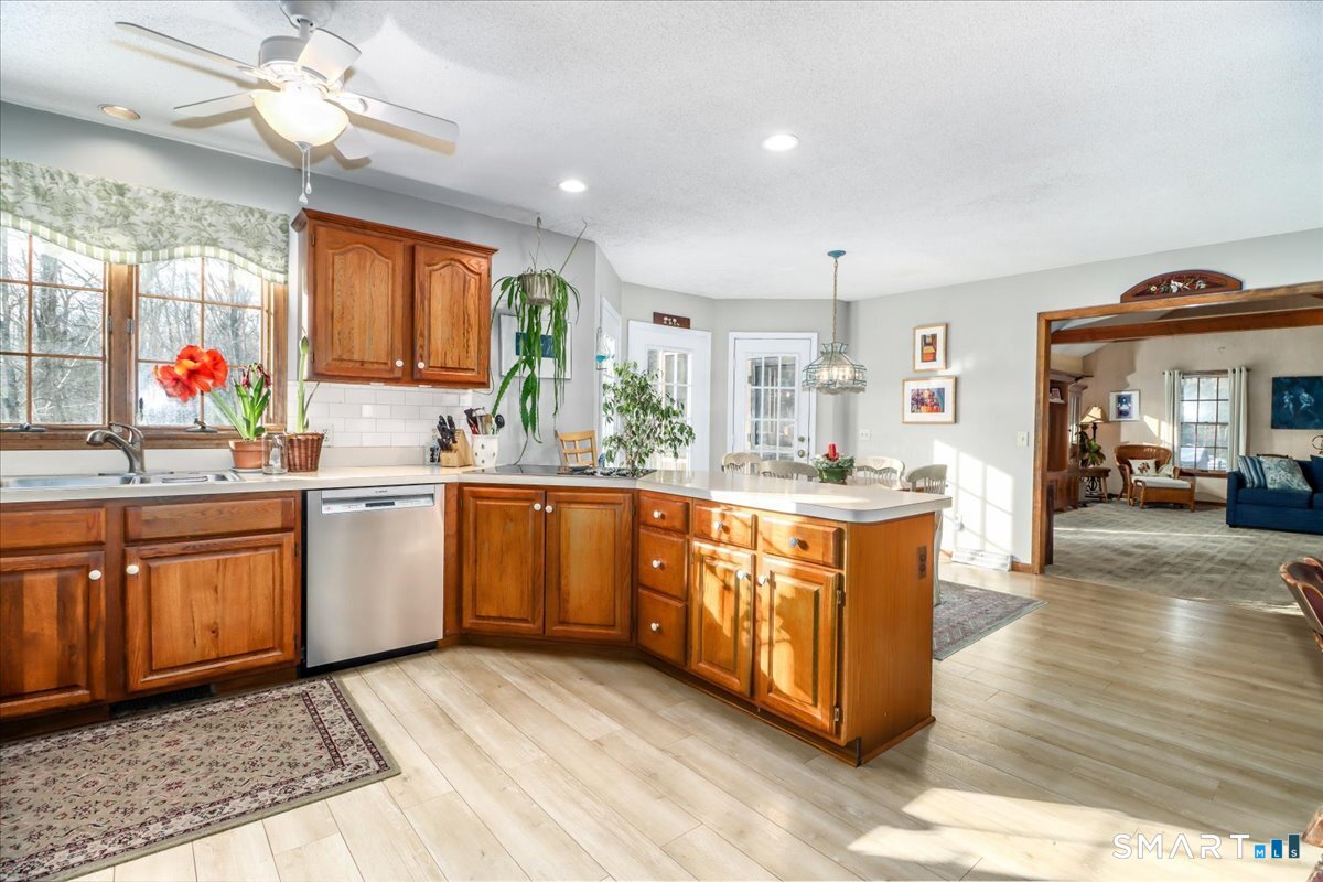 185 Quaker Farms Road Oxford, CT 06478 - Photo 11 of 40 a large kitchen with stainless steel appliances kitchen island granite countertop a sink cabinets and window