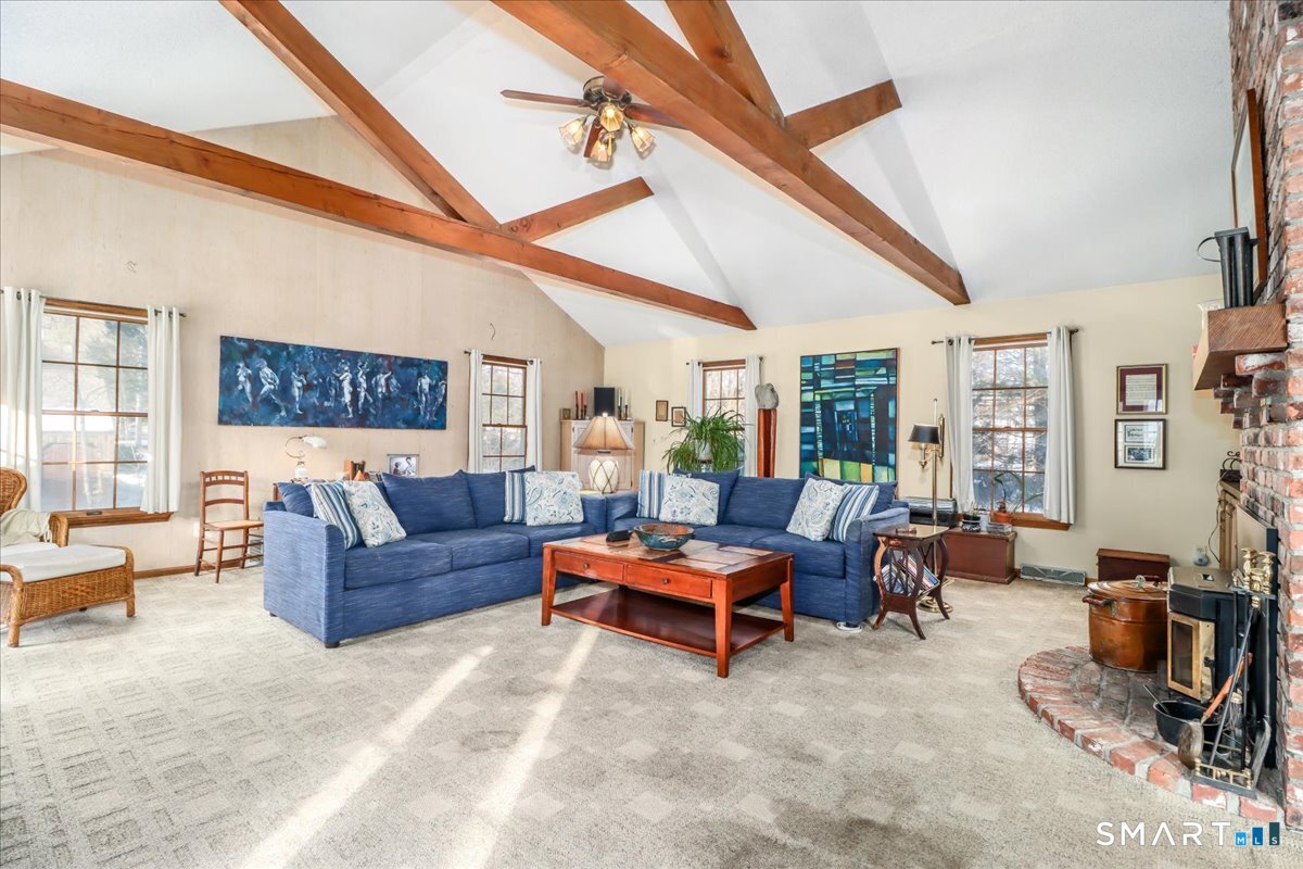 185 Quaker Farms Road Oxford, CT 06478 - Photo 12 of 40 a living room with furniture gym equipment and large windows
