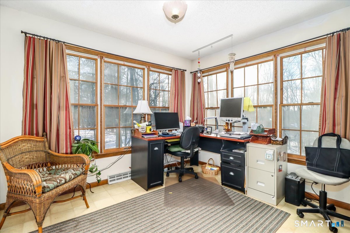 185 Quaker Farms Road Oxford, CT 06478 - Photo 16 of 40 a view of a workspace with furniture and a window