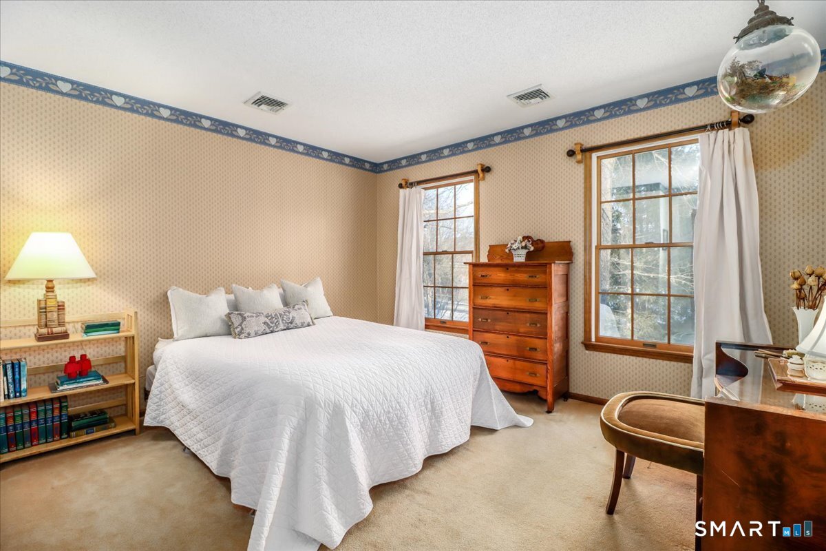 185 Quaker Farms Road Oxford, CT 06478 - Photo 17 of 40 a bedroom with a bed and a desk