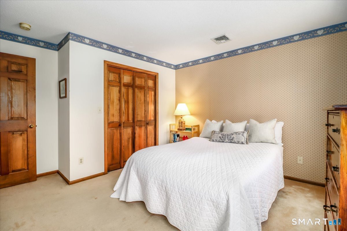 185 Quaker Farms Road Oxford, CT 06478 - Photo 18 of 40 a bedroom with a bed and a window