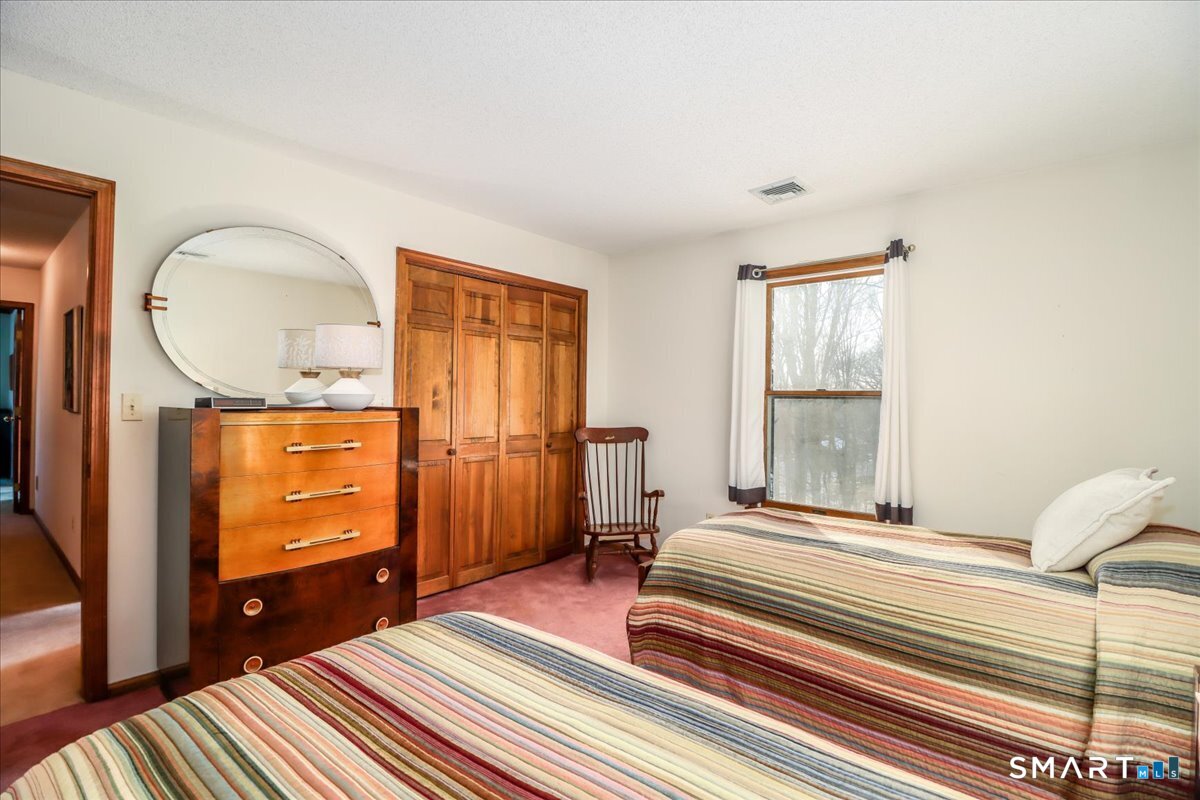 185 Quaker Farms Road Oxford, CT 06478 - Photo 20 of 40 a bedroom with a bed and wooden floor