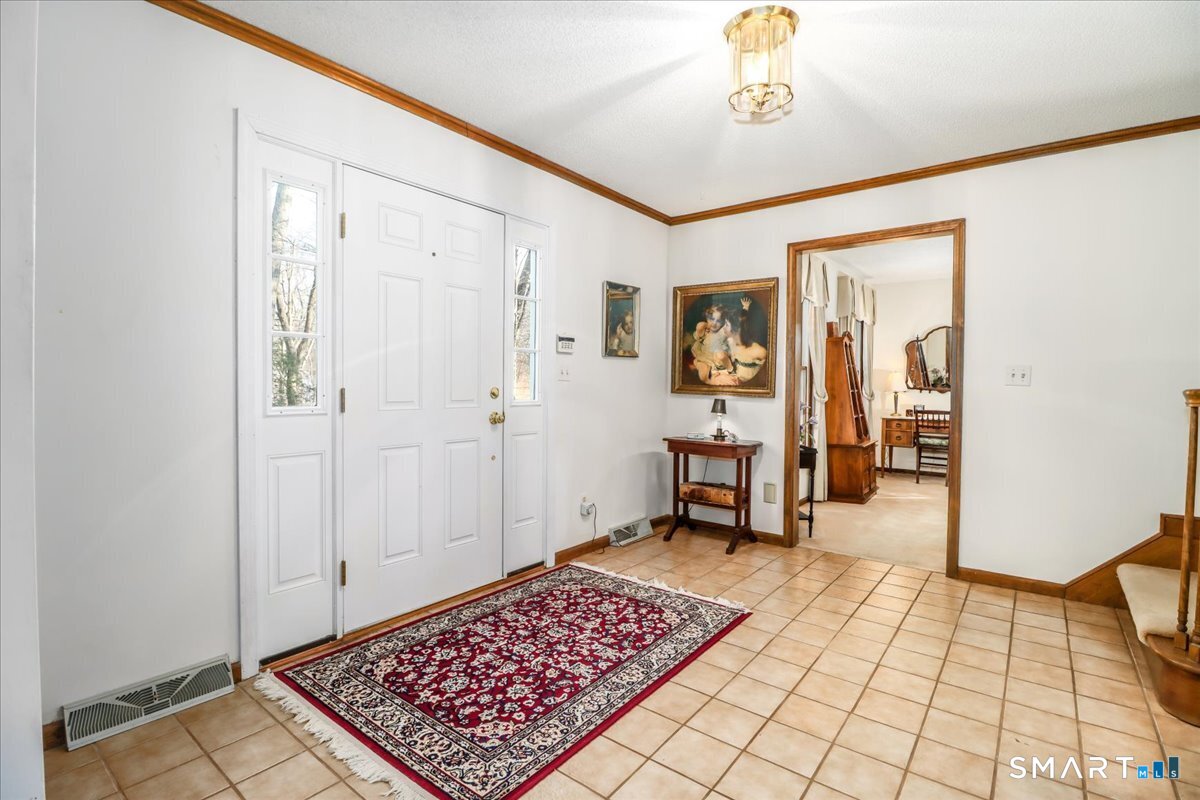 185 Quaker Farms Road Oxford, CT 06478 - Photo 2 of 40 a view of a hallway with wooden floor and a bathroom