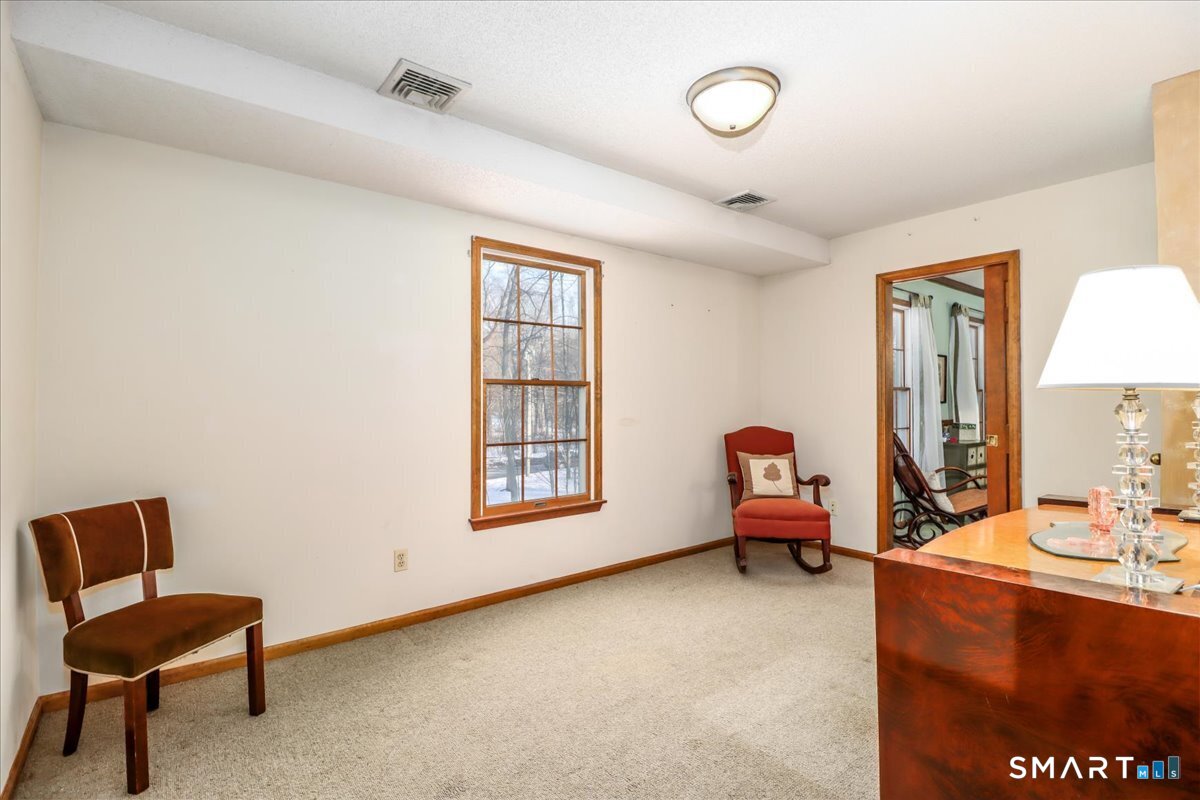 185 Quaker Farms Road Oxford, CT 06478 - Photo 22 of 40 a living room with furniture and a window