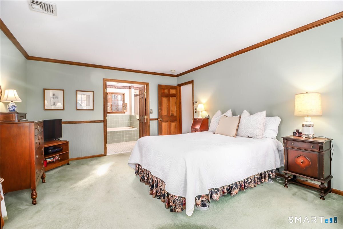 185 Quaker Farms Road Oxford, CT 06478 - Photo 25 of 40 a spacious bedroom with a bed and furniture