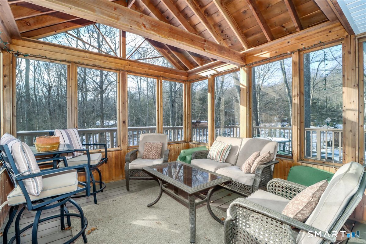 185 Quaker Farms Road Oxford, CT 06478 - Photo 29 of 40 a living room with furniture and a floor to ceiling window