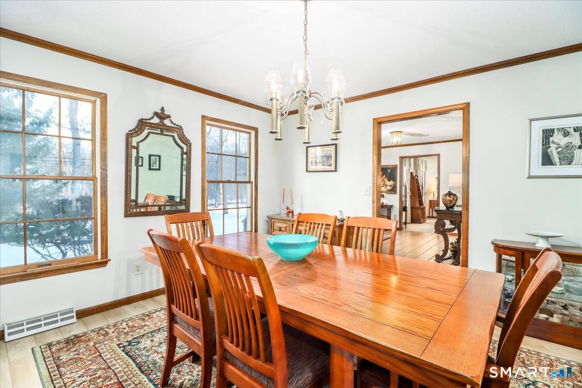 185 Quaker Farms Road Oxford, CT 06478 - Photo 5 of 40 a view of a dining room with furniture large window and wooden floor