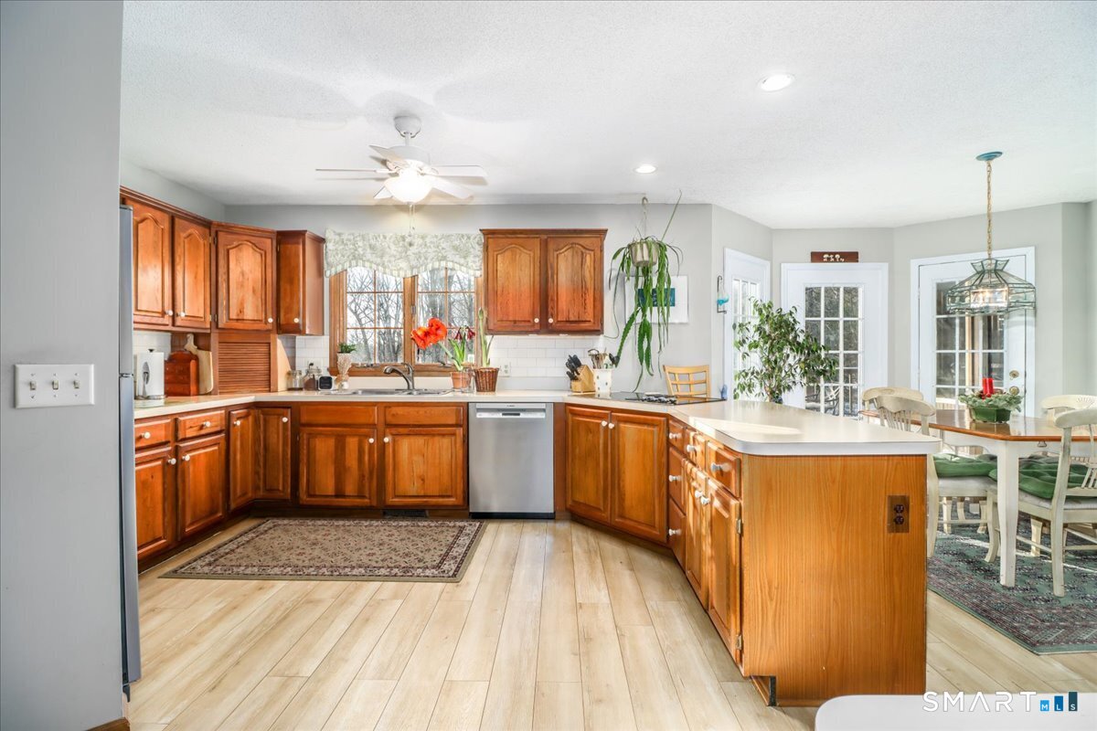 185 Quaker Farms Road Oxford, CT 06478 - Photo 8 of 40 a kitchen with lots of counter top space and dining table