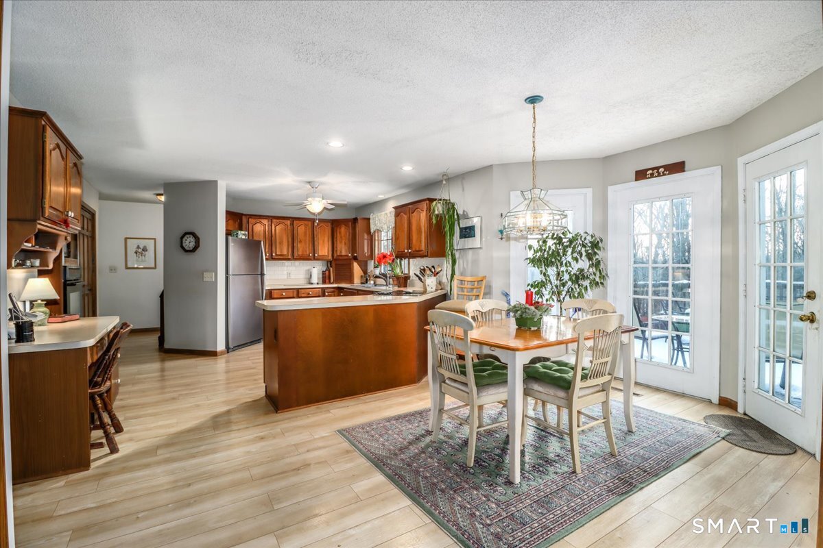 185 Quaker Farms Road Oxford, CT 06478 - Photo 9 of 40 a view of a dining room with furniture window and wooden floor