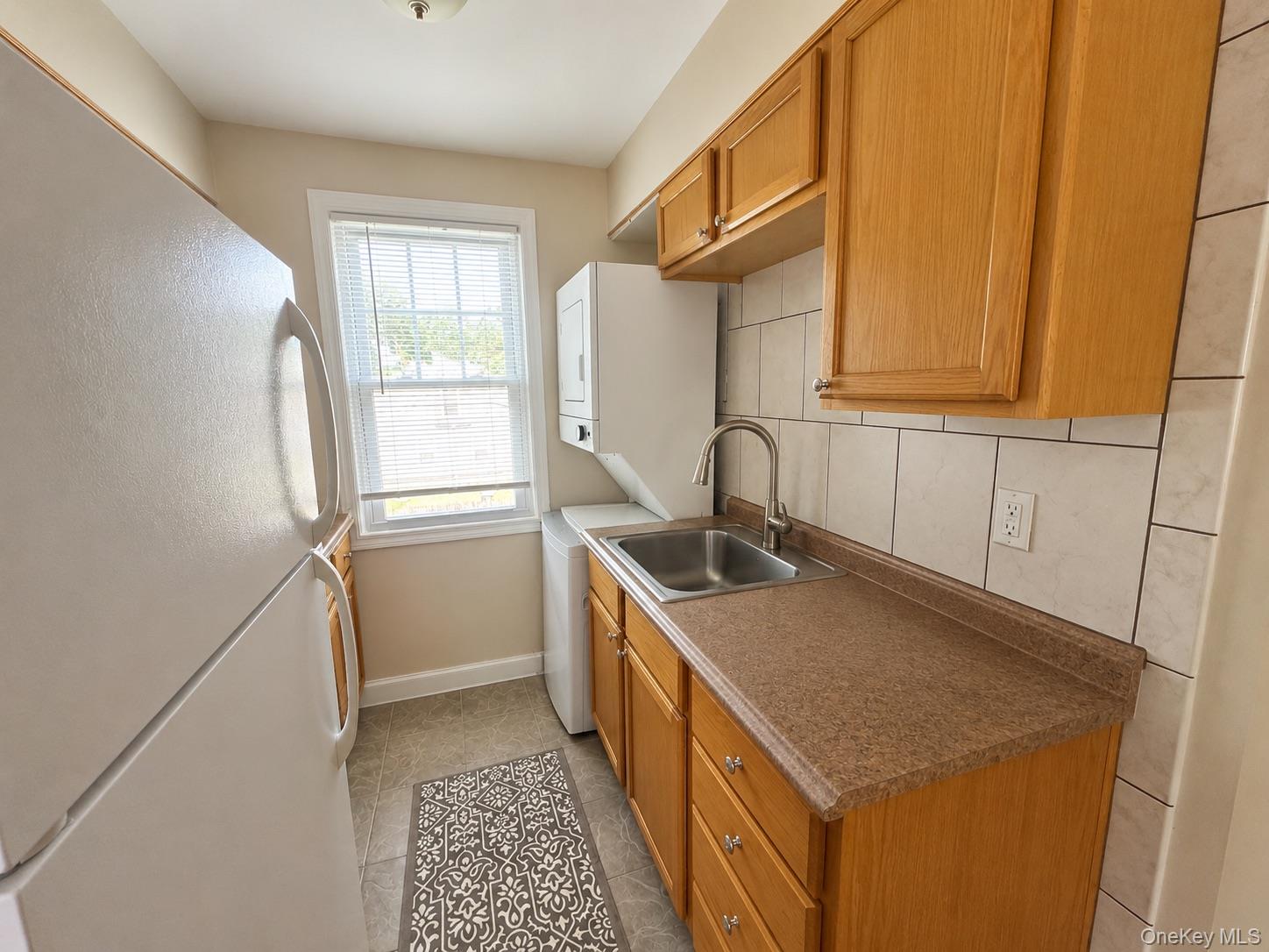 90 Orchard Road, Unit 2 Mahopac, NY 10541 - Photo 5 of 7 a kitchen with a sink a stove and a refrigerator