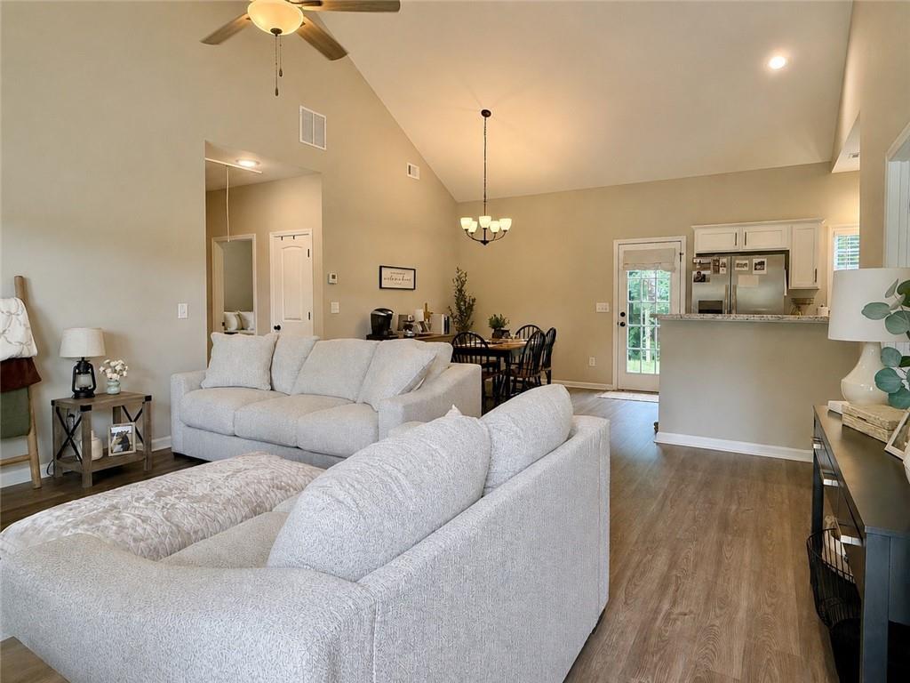 1776 Pleasant Grove Road Temple, GA 30179 - Photo 6 of 45 a living room with furniture a dining table and chairs with the view of kitchen