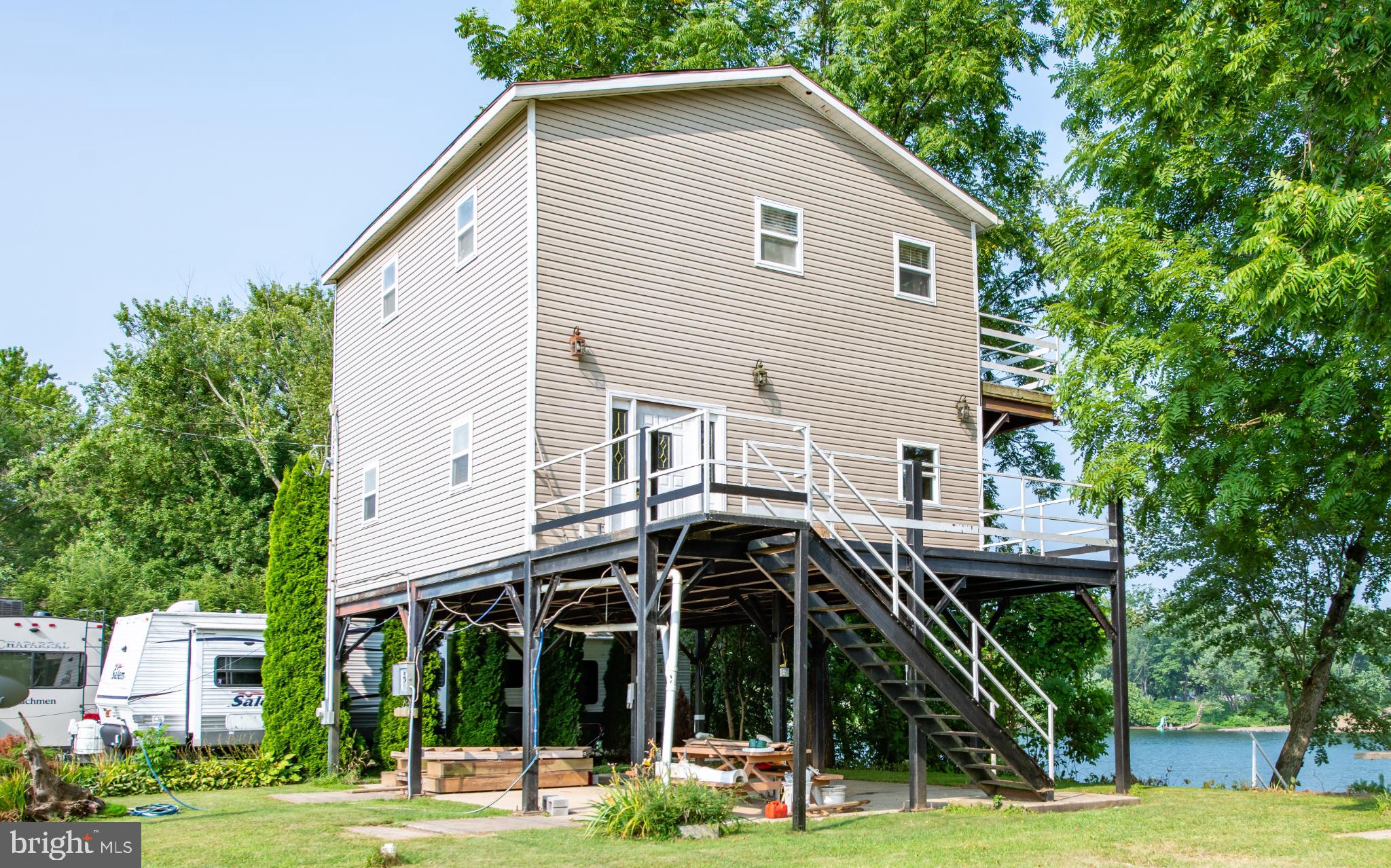 a view of a house with a yard and furniture