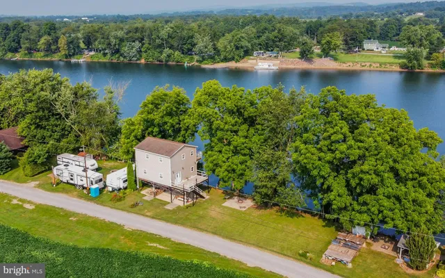 an aerial view of a house with a lake view
