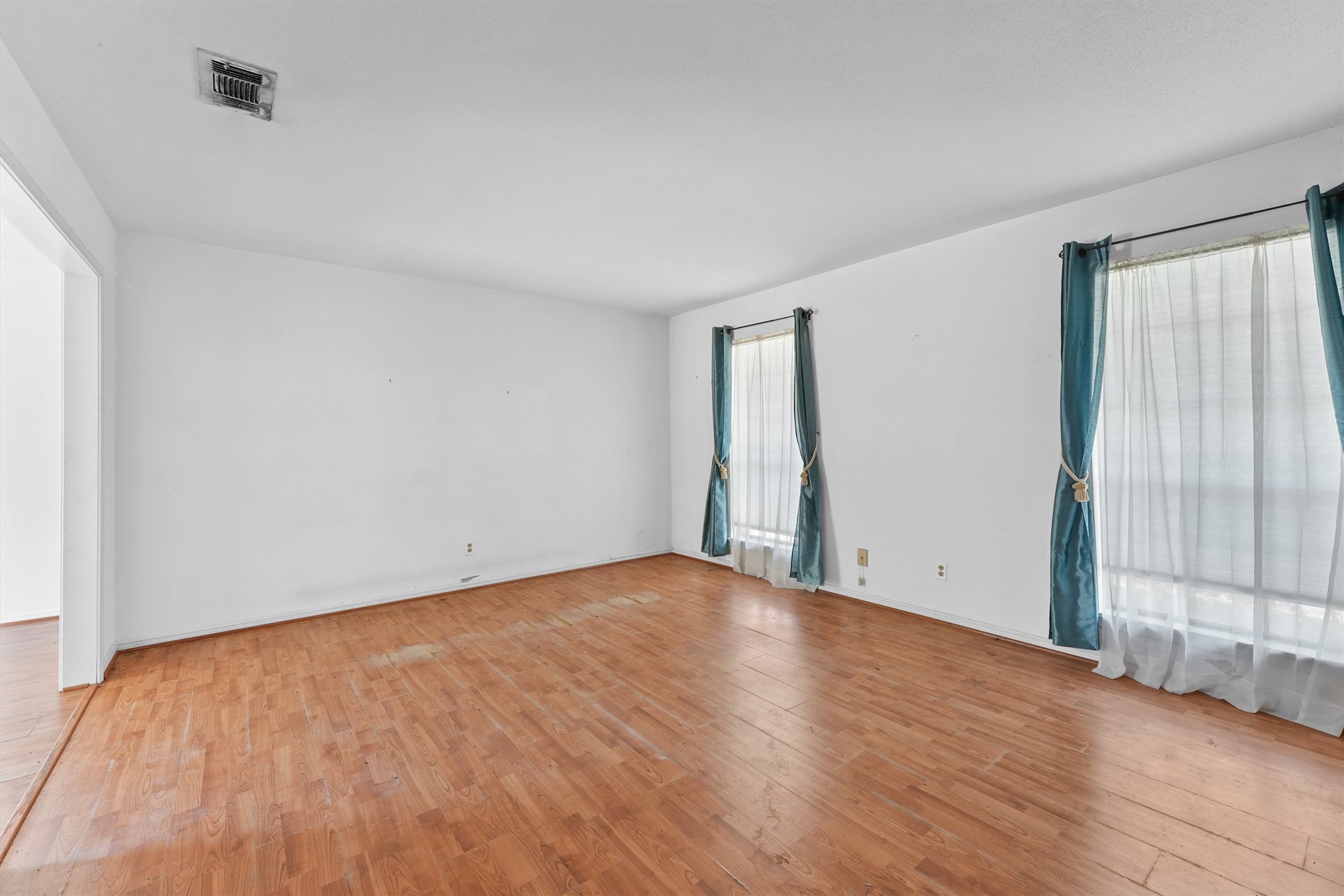 3930 Cypress Hill Drive Spring, TX 77388 - Photo 6 of 29 a view of an empty room with wooden floor and a window