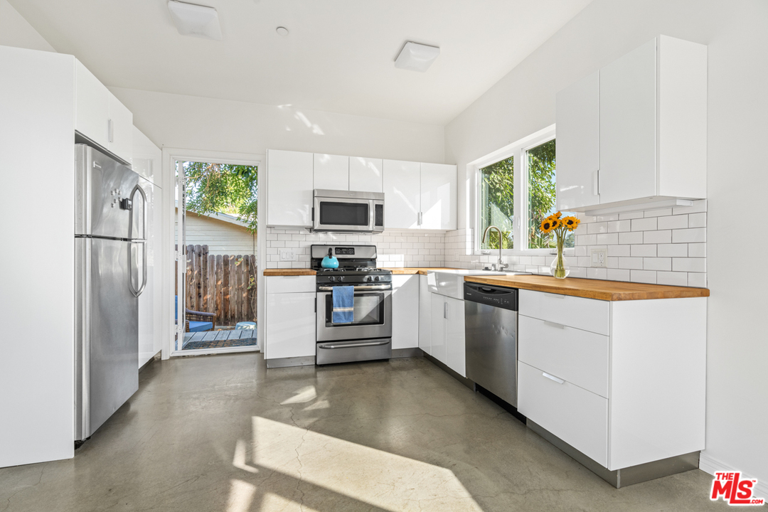 2275 Ewing Street Los Angeles, CA 90039 - Photo 8 of 19 a kitchen with stainless steel appliances a refrigerator sink and microwave