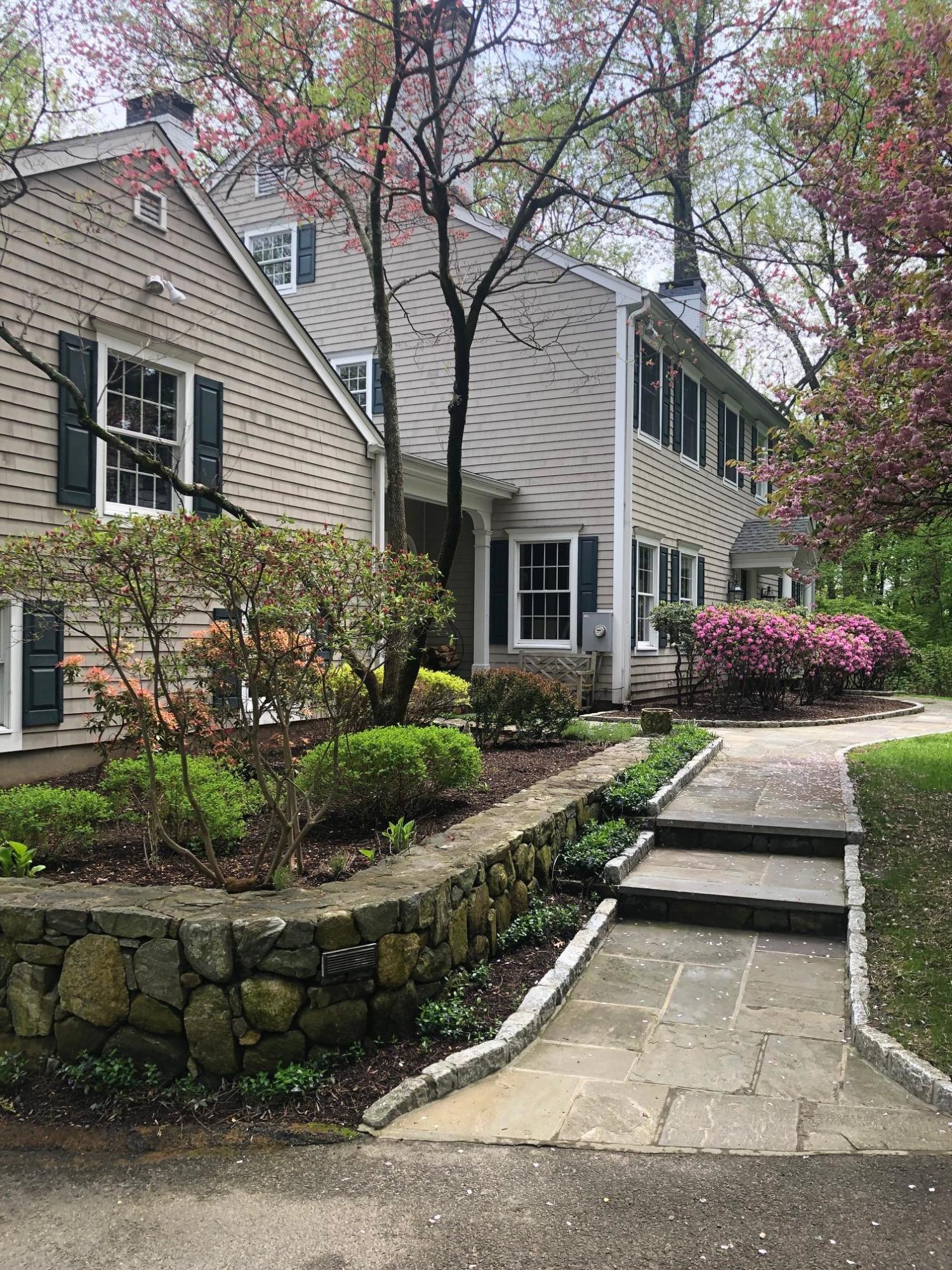 152 Marshall Ridge Road New Canaan, CT 06840 - Photo 2 of 34 a front view of a house with a garden