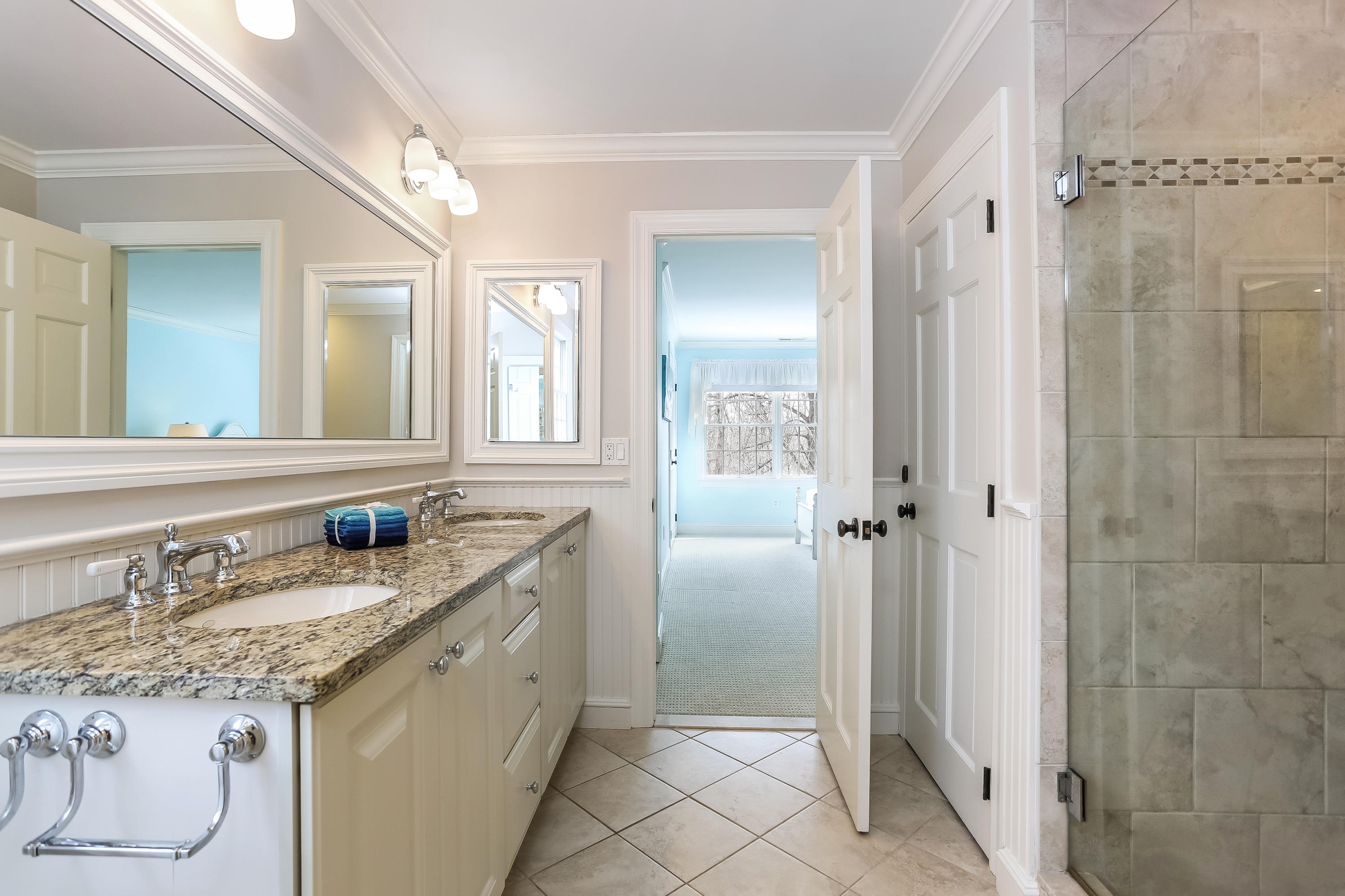 152 Marshall Ridge Road New Canaan, CT 06840 - Photo 24 of 34 a bathroom with a granite countertop sink and a mirror
