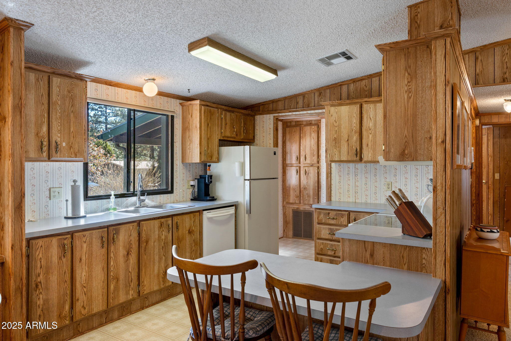 2841 Pine Rim Road Overgaard, AZ 85933 - Photo 12 of 36 a kitchen with stainless steel appliances granite countertop a sink and a refrigerator