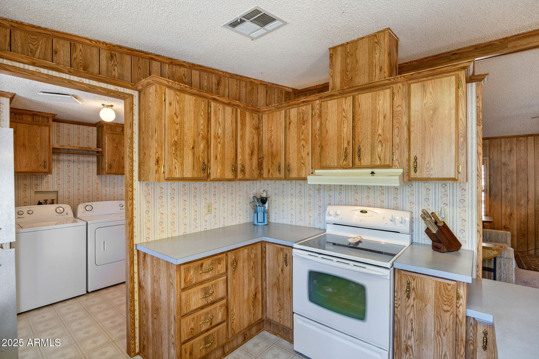2841 Pine Rim Road Overgaard, AZ 85933 - Photo 14 of 36 a kitchen with stainless steel appliances granite countertop a sink a stove and a refrigerator