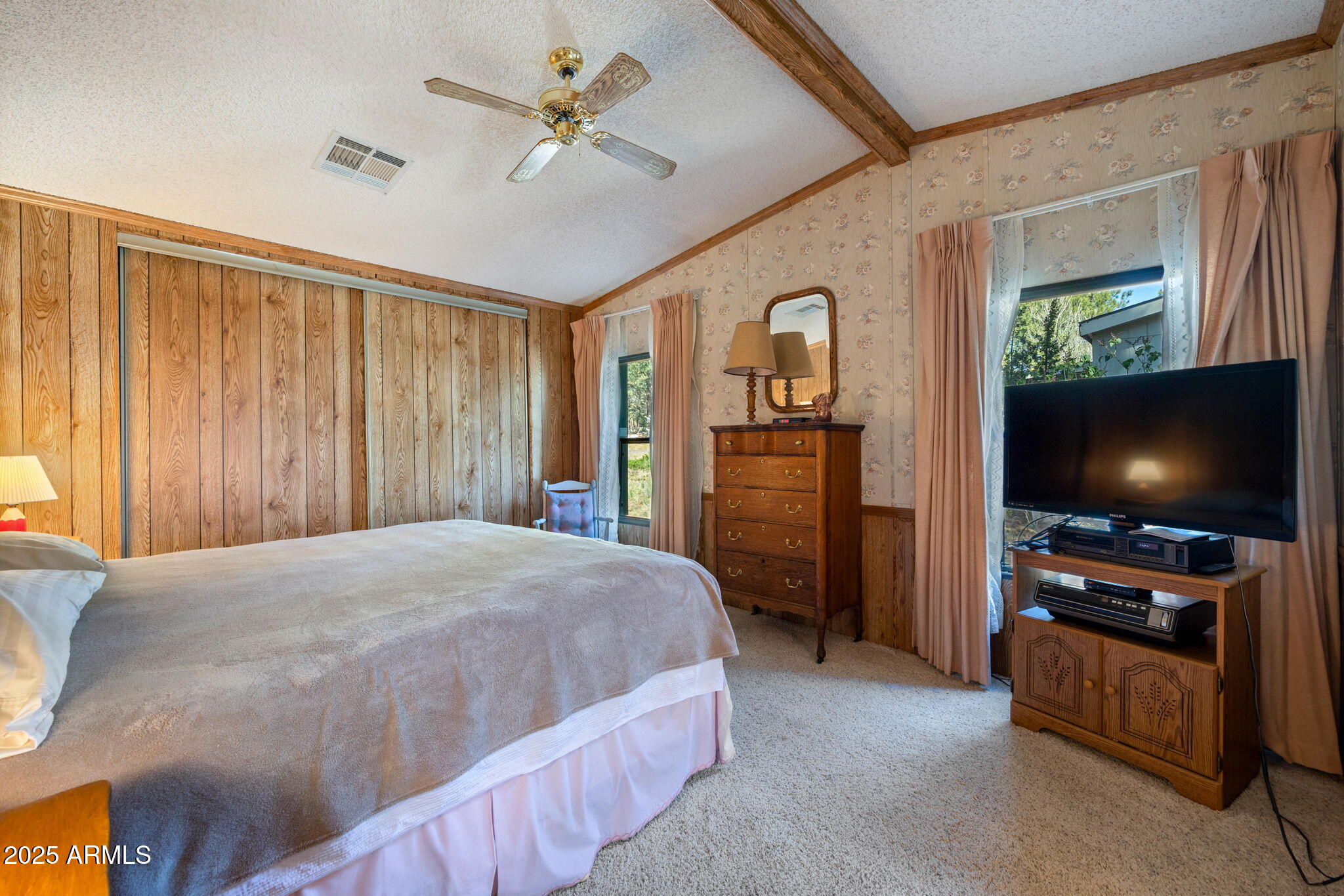 2841 Pine Rim Road Overgaard, AZ 85933 - Photo 15 of 36 a bedroom with a bed and a flat screen tv