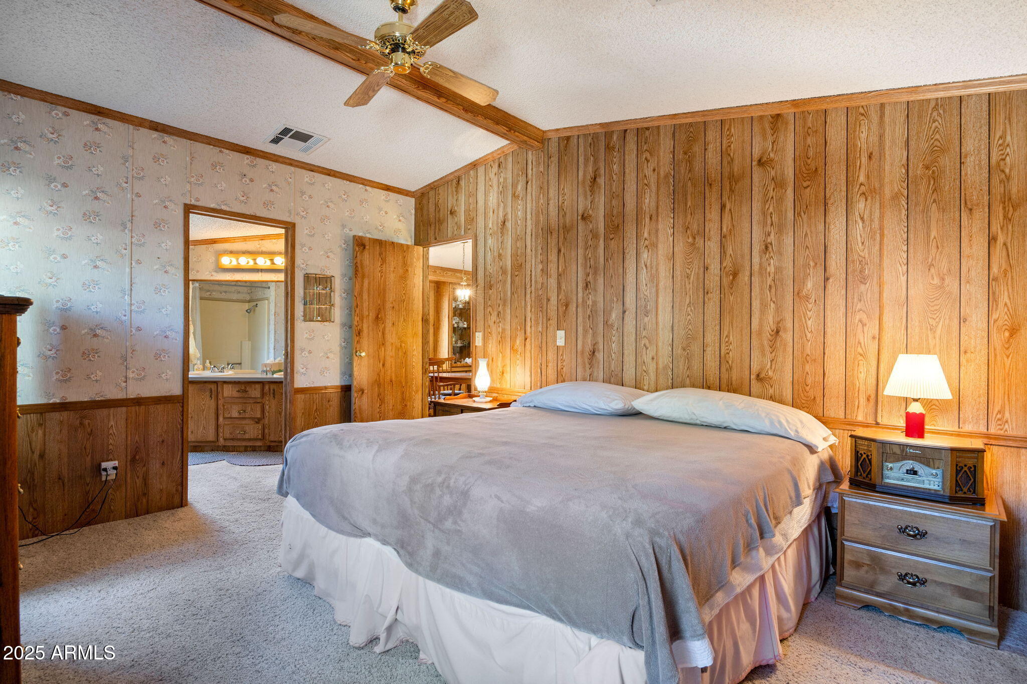 2841 Pine Rim Road Overgaard, AZ 85933 - Photo 16 of 36 a bedroom with a bed and a chandelier