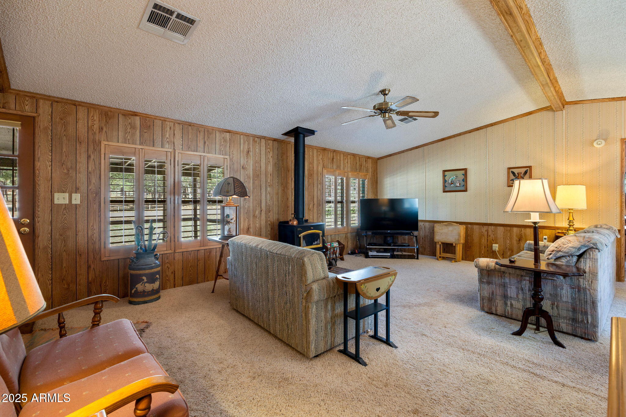 2841 Pine Rim Road Overgaard, AZ 85933 - Photo 10 of 36 a living room with furniture a flat screen tv and a window