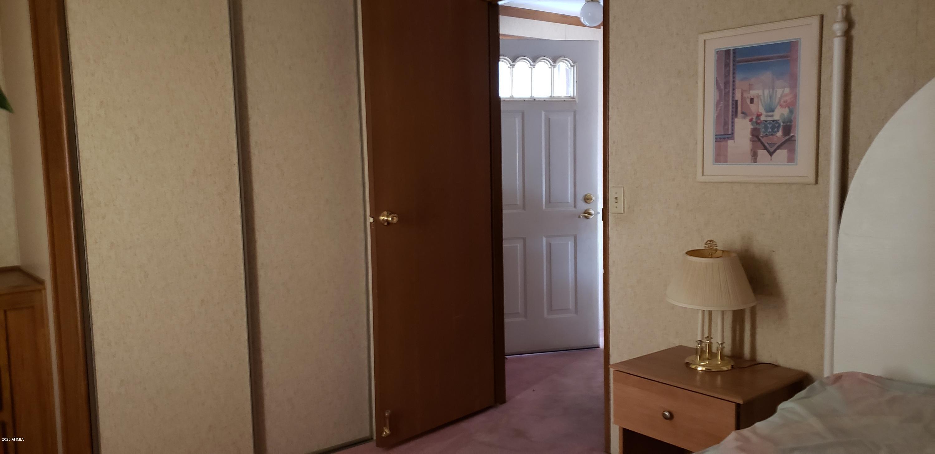 301 South Signal Butte Road, Unit 735 Apache Junction, AZ 85120 - Photo 14 of 27 a view of a hallway with workspace and mirror
