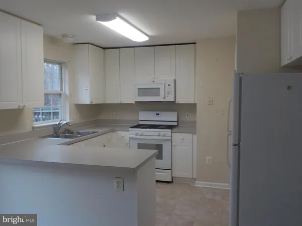 a kitchen with a stove a sink and a refrigerator