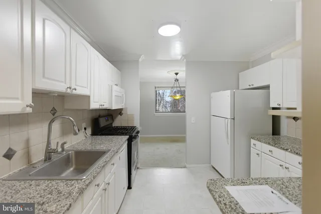a kitchen with refrigerator cabinets and stove