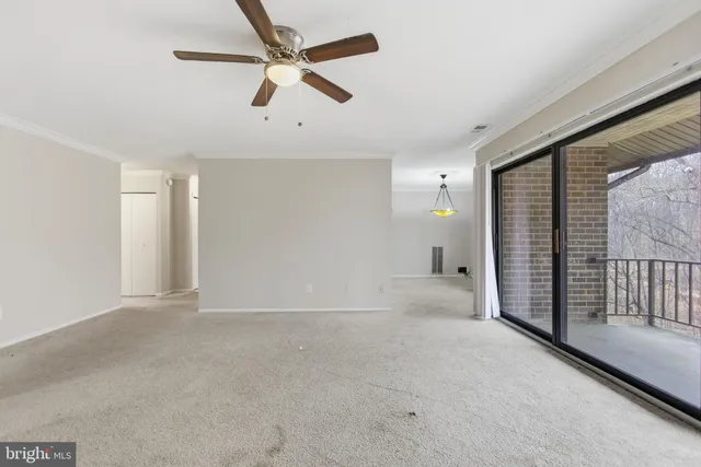 a view of a livingroom with a ceiling fan and window