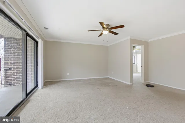 a view of room with hardwood floor and ceiling fan