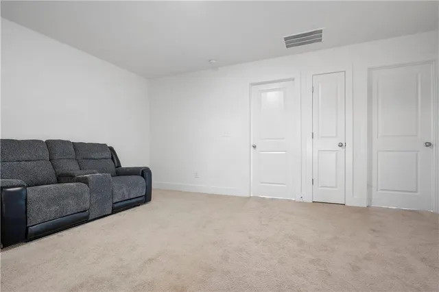 a living room with furniture and closet