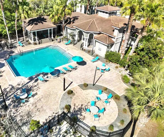 a view of a swimming pool with a dining table and chairs