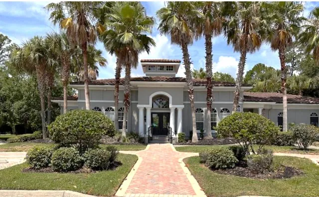 a front view of a house with a garden