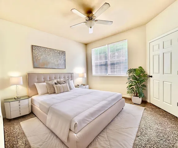 a bedroom with a bed and window