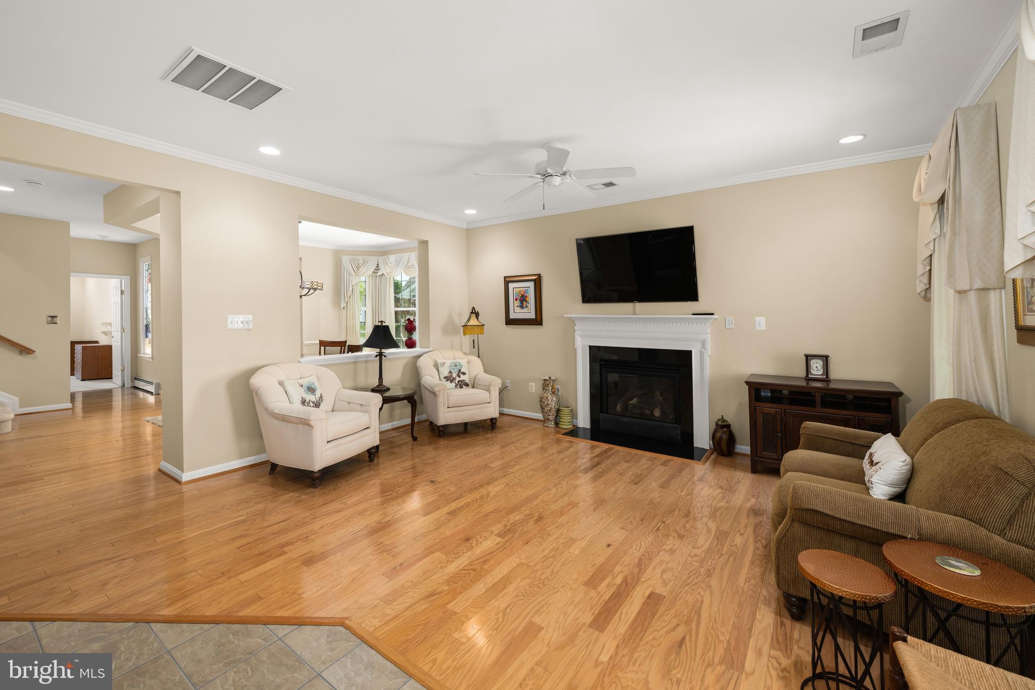 152 Widgeon Way Bridgeville, DE 19933 - Photo 4 of 37 a living room with furniture flat screen tv and a fireplace
