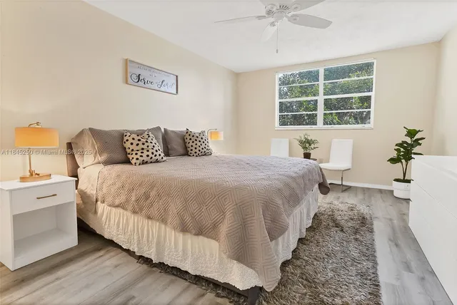 a spacious bedroom with a bed and a window