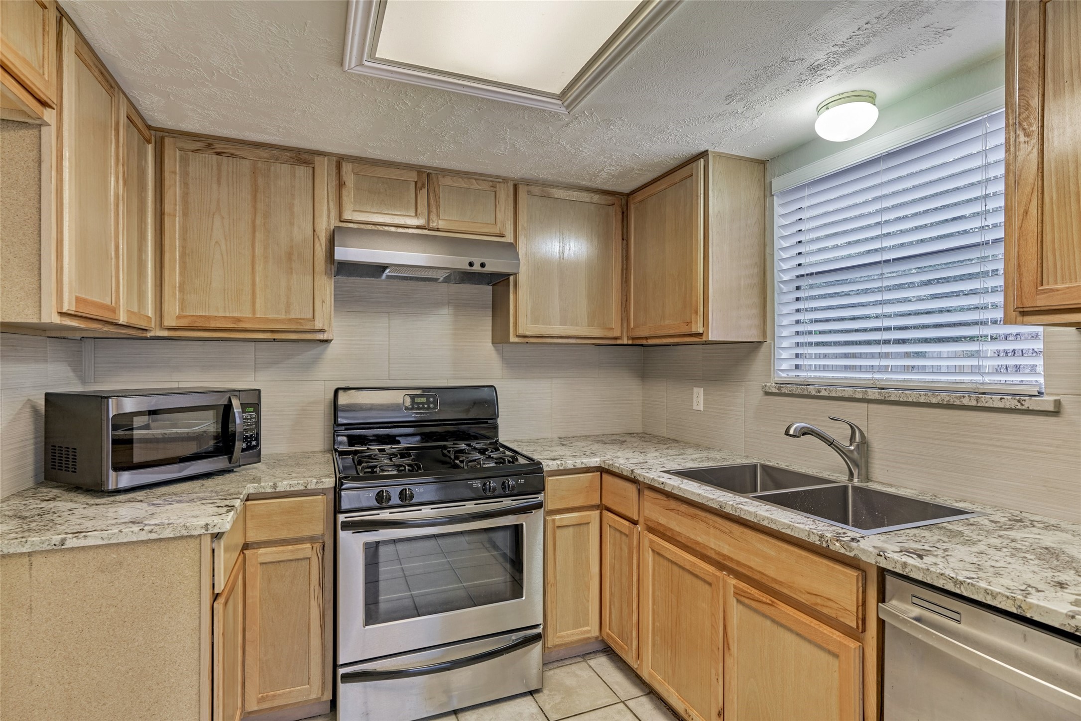 3 Field Flower Court Spring, TX 77380 - Photo 16 of 36 a kitchen with cabinets appliances and a sink