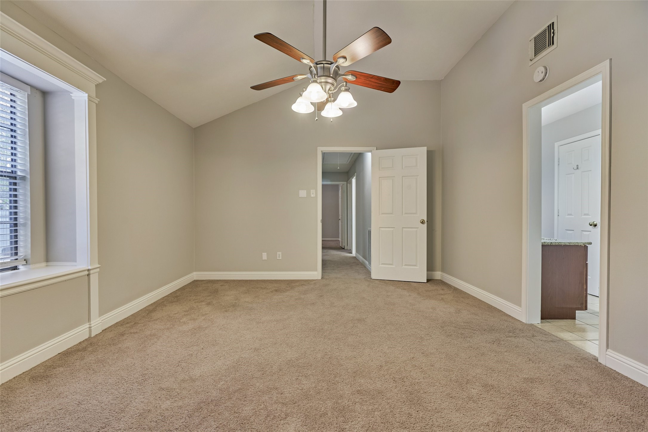3 Field Flower Court Spring, TX 77380 - Photo 21 of 36 an empty room with a ceiling fan and a window
