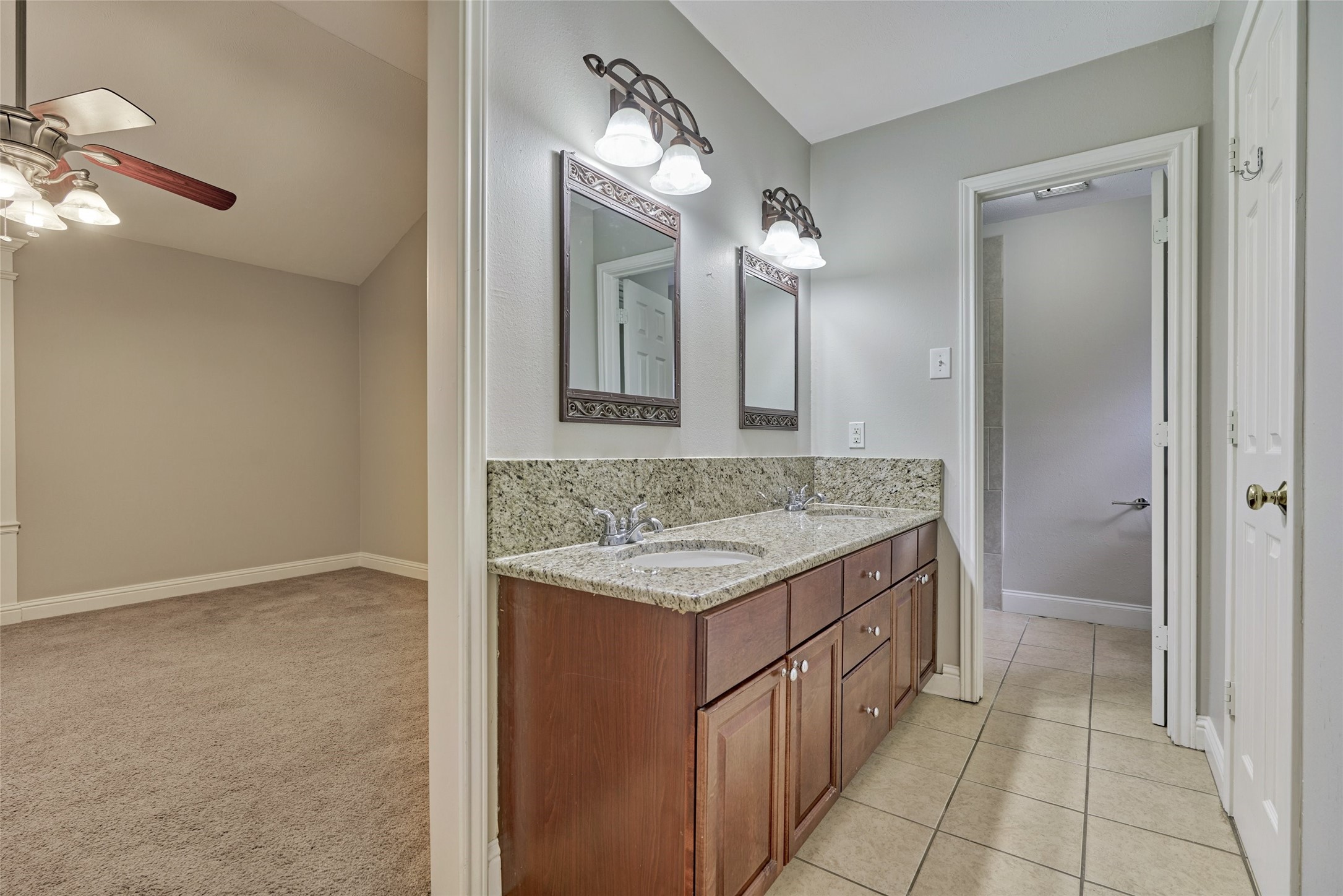 3 Field Flower Court Spring, TX 77380 - Photo 22 of 36 a bathroom with a granite countertop sink and a mirror
