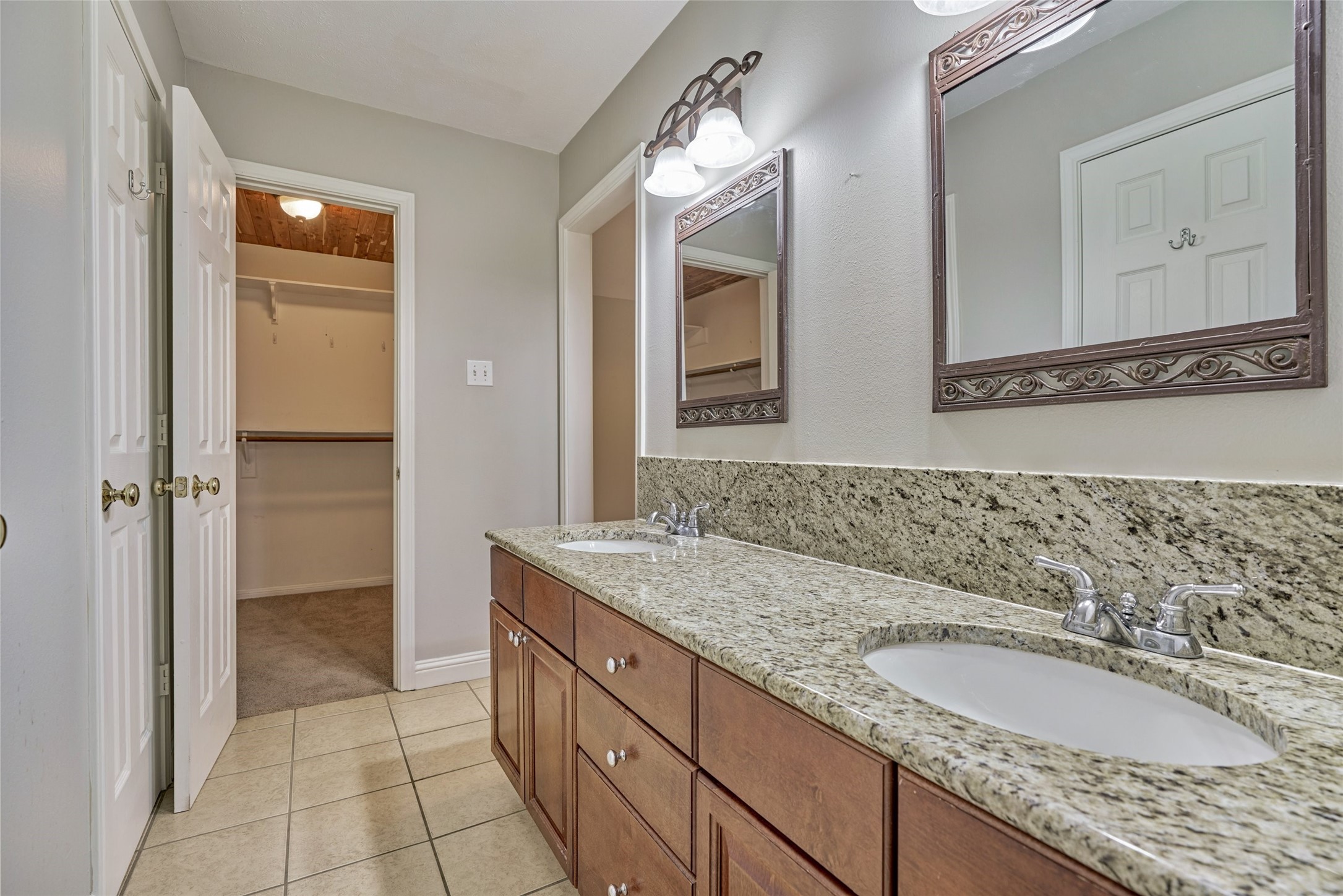 3 Field Flower Court Spring, TX 77380 - Photo 24 of 36 a bathroom with a granite countertop sink and a mirror