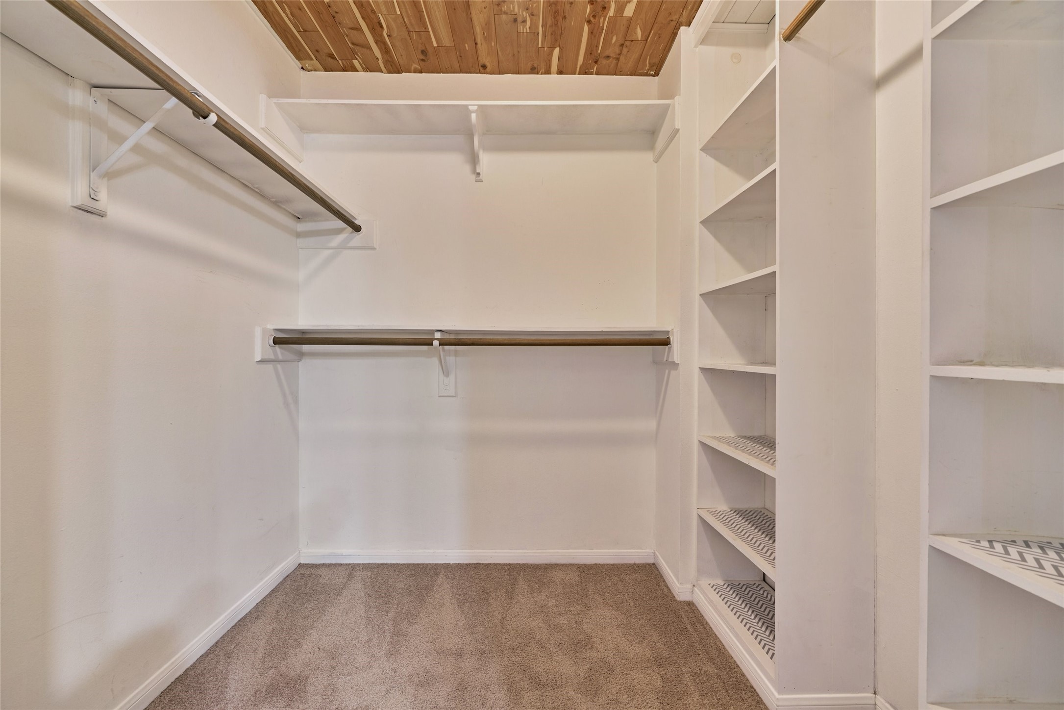 3 Field Flower Court Spring, TX 77380 - Photo 25 of 36 a view of walk in closet with empty racks