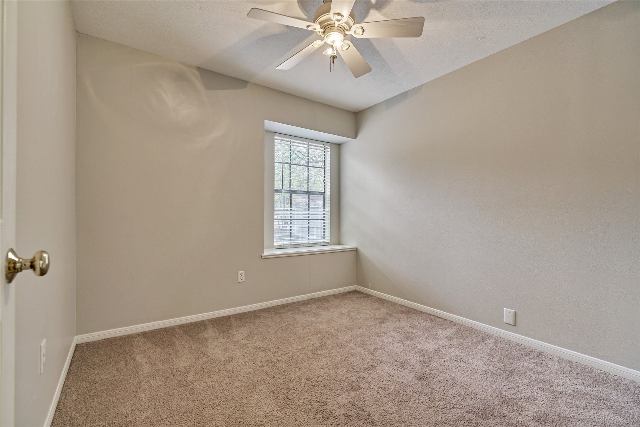 3 Field Flower Court Spring, TX 77380 - Photo 26 of 36 an empty room with windows and fan